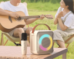 A boy is playing guitar and a girl is listening, with a bluetooth speaker in front