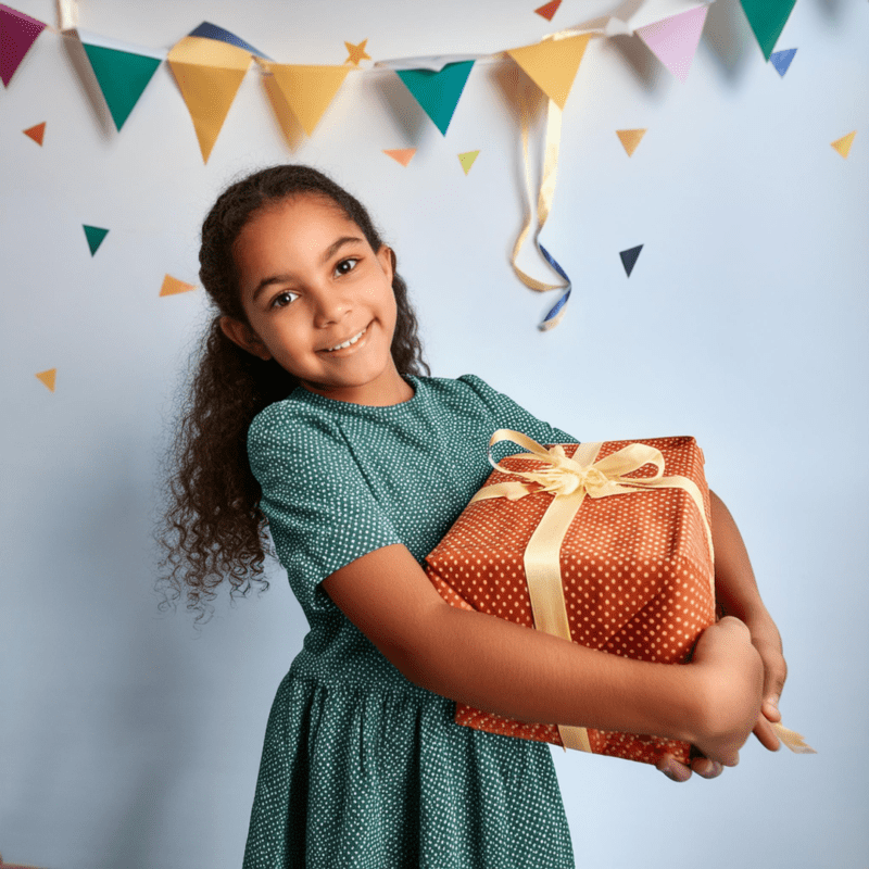 A girl is holding a gift containing electronic products